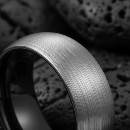 8mm brushed silver black tungsten carbide ring for men
Tungsten wedding band black interior comfort fit
Men's tungsten ring side view showing brushed finish
Custom engraved tungsten ring inner band
Man wearing black silver tungsten wedding band
